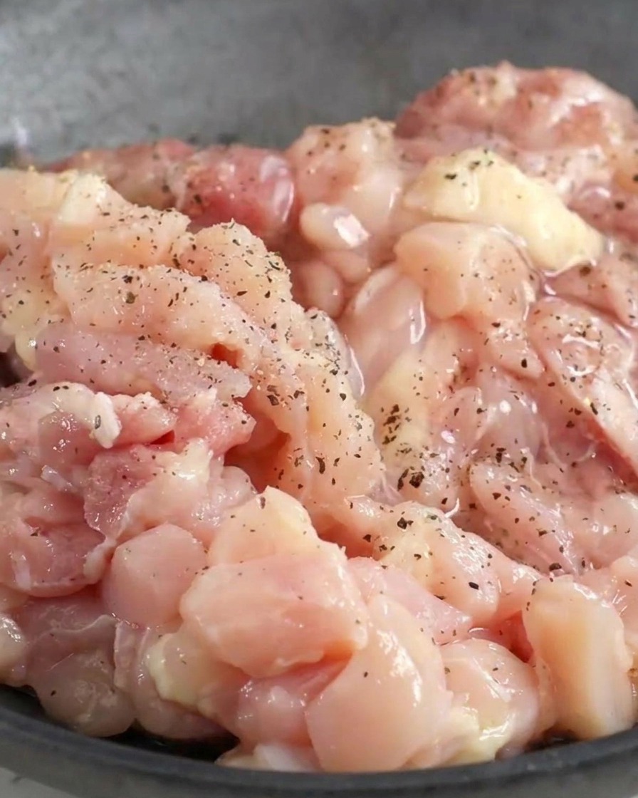 Poulet haché dans un bol avec les assaisonnements.