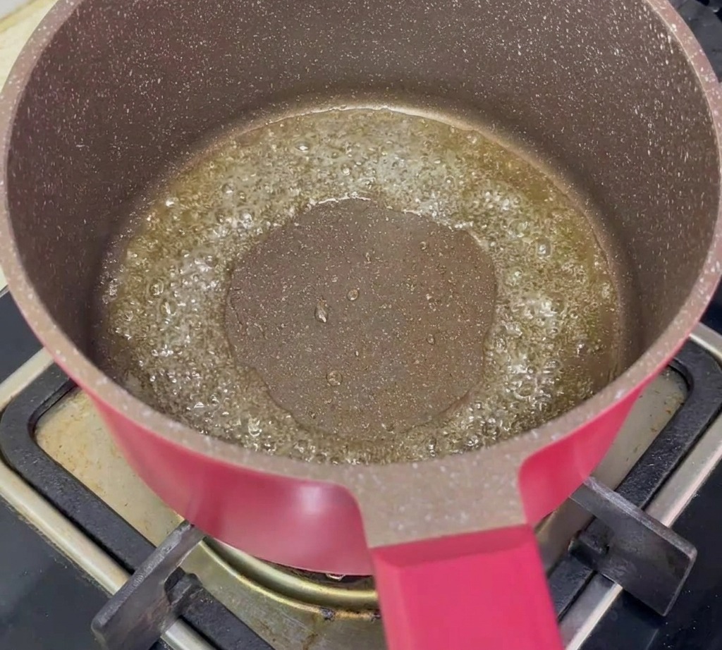 Carottes en dés et cébettes hachées sautant dans une poêle avec de lhuile chaude.