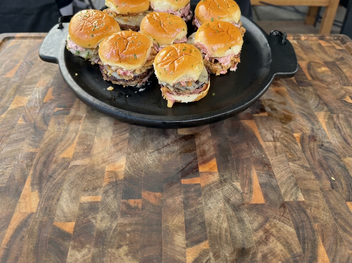Patties de dinde grillant sur une plancha, avec des bords dorés.