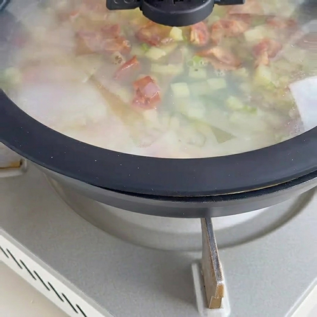 Base de chowder crémeuse mijotant avec les palourdes.