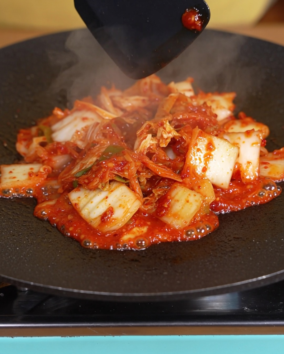 Kimchi cuit dans la poêle avec le liquide visiblement réduit.