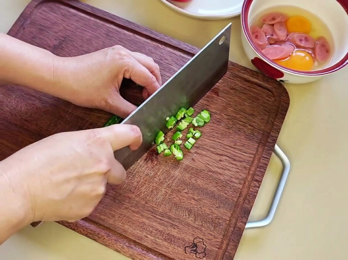 Piment vert finement haché sur une planche.