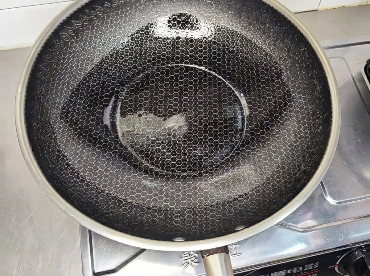 Steak de poulet en train de dorer dans un wok chaud.