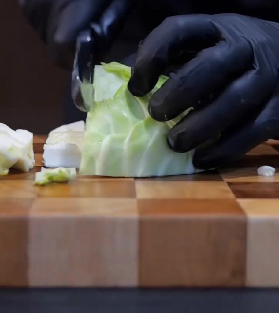 Du chou frais coupé en petits morceaux sur une planche à découper en bois.