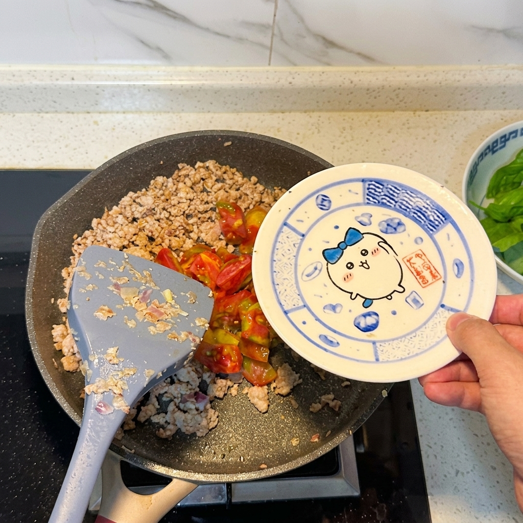 Tomates en dés ajoutées dans la poêle contenant la viande dorée.