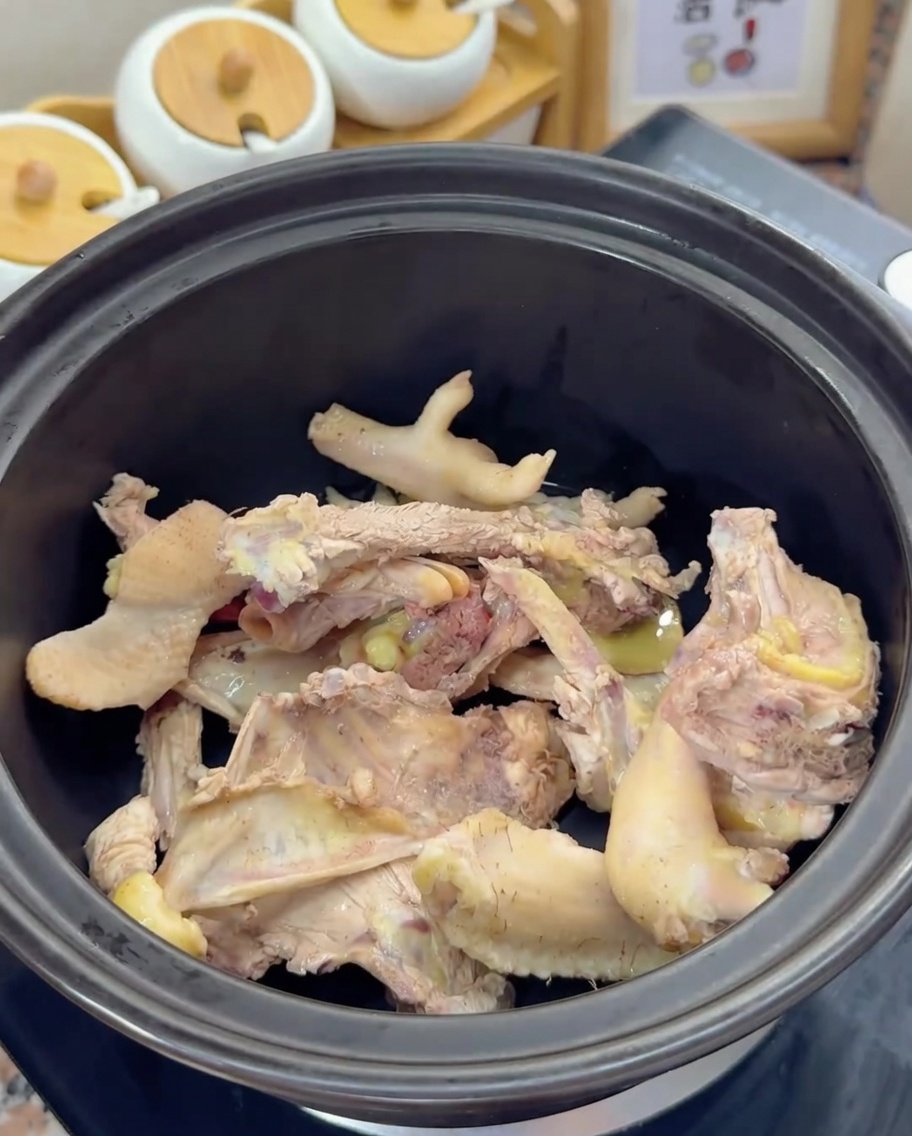 Os de poulet blanchis reposant au fond dun pot dargile noir.