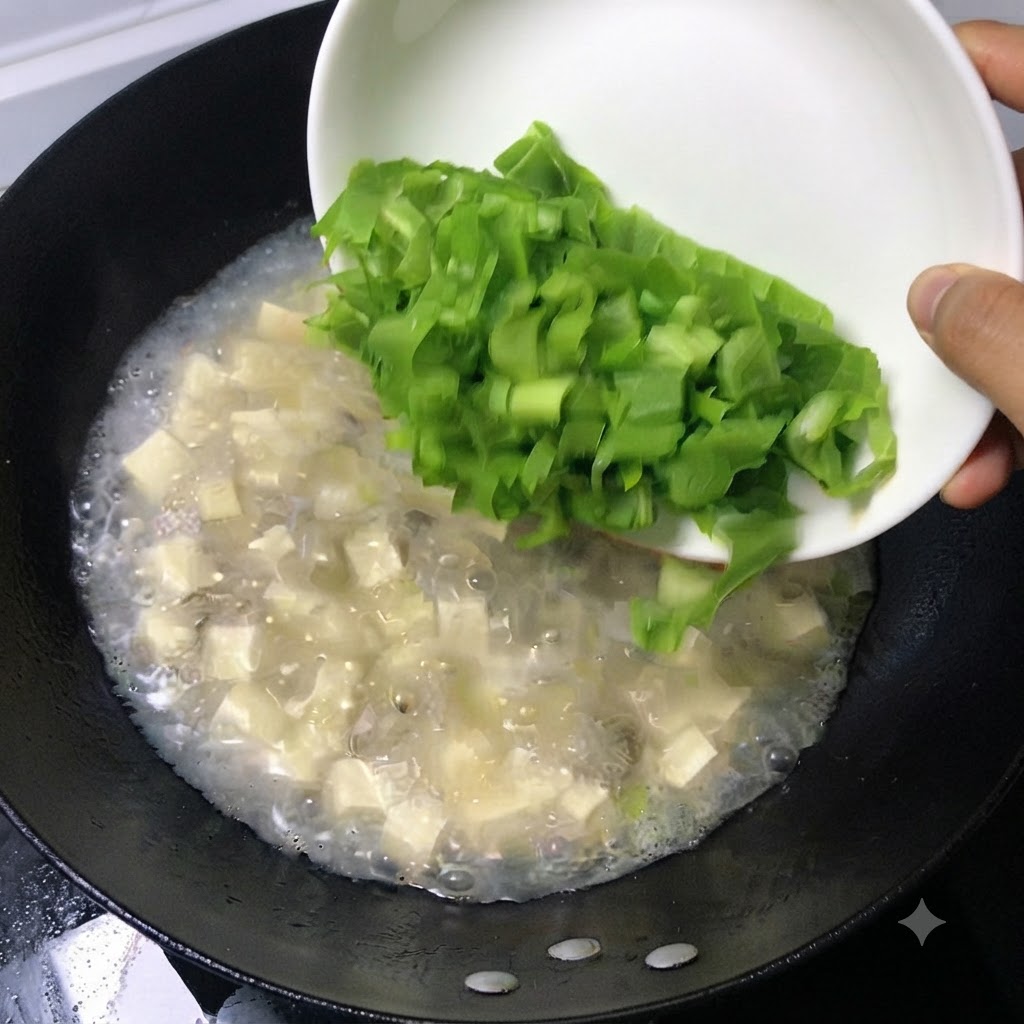 Des feuilles vertes fraîches hachées glissant dun plat blanc dans une casserole de soupe bouillonnante.