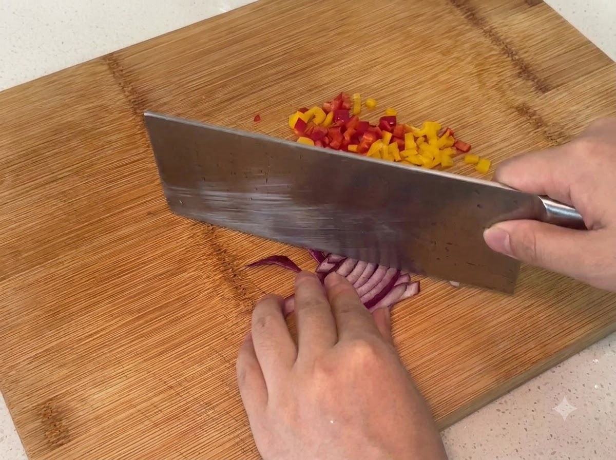 Oignon rouge coupé en petits morceaux sur une planche à découper en bois.