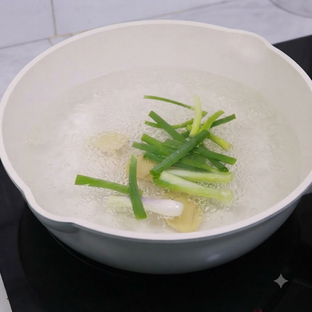 Tranches de gingembre et oignons nouveaux bouillant dans de leau avec du vin de cuisine.