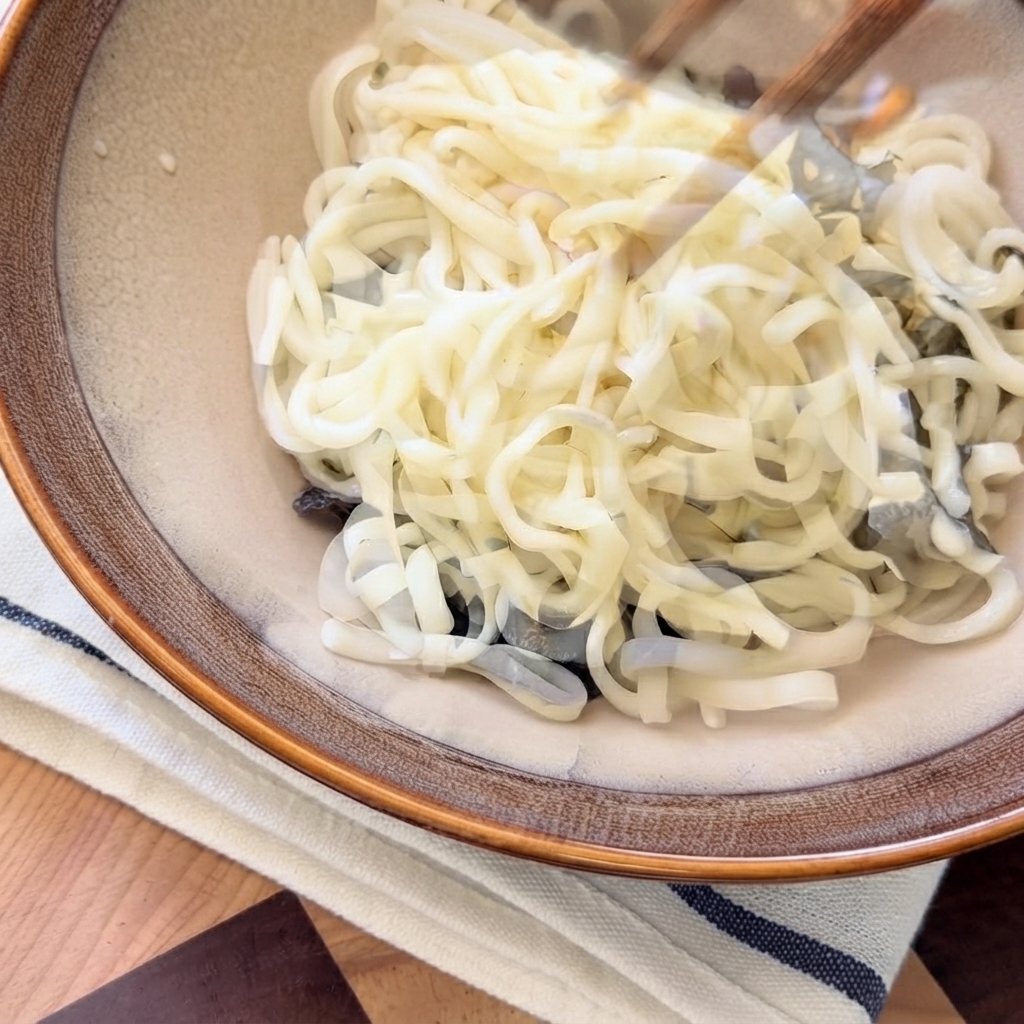 De la soupe de champignons chaude versée par le dessus sur les nouilles à lintérieur du bol de service.
