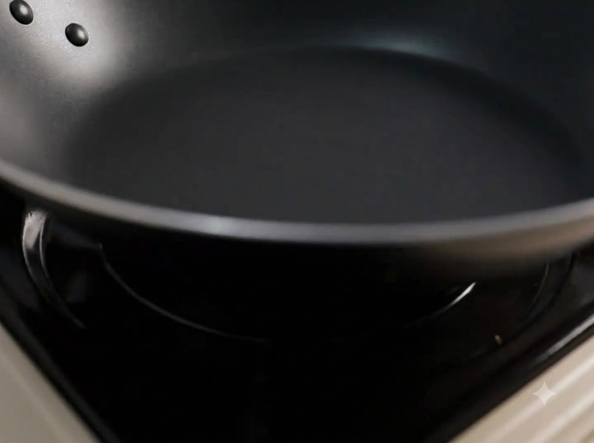 De lhuile de cuisine versée dans une poêle noire préchauffée.