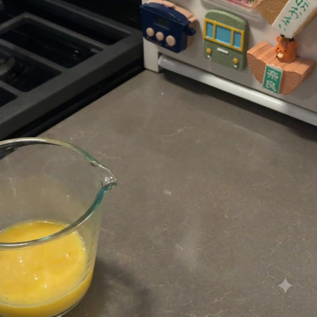 Un pinceau à pâtisserie enduisant soigneusement le dessus des pains à burger levés avec une dorure à lœuf.