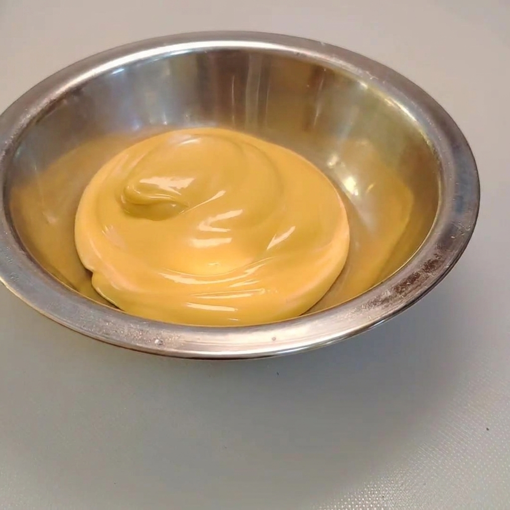 Du wasabi pressé dans un bol en métal rempli de sauce salade au fromage crémeuse.